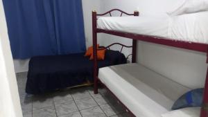 a bedroom with two bunk beds and a blue curtain at El Cordobés in San Juan