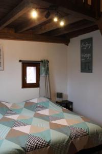 een slaapkamer met een kleurrijk bed in een kamer bij La p'tite maison in Orschwihr