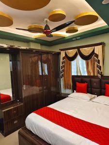 a bedroom with a bed with a ceiling fan at Alif serviced Apartment for Families and Executives in Tambaram