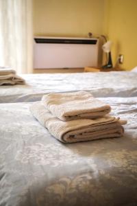 a pile of towels sitting on top of a bed at ΕΥΕΛΗ in Edessa