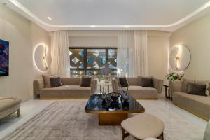 a living room with a couch and a table at Usmans 4BDRM APARTMENT SEA VIEW Rimal in Dubai