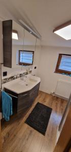 a large bathroom with a sink and a mirror at Appartement Gletscher-Koje in Tux