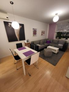 a living room with a table and a couch at Apartman Jarun lake in Zagreb