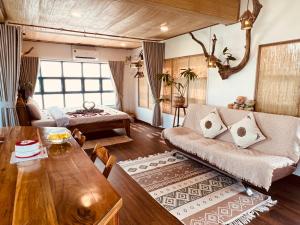 a living room with a couch and a table at TỊNH Retreat Phu Quoc in Phú Quốc