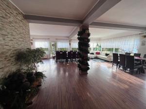 a large living room with a table and chairs at The Brothers House Bran in Bran