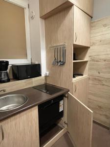 a small kitchen with a sink and a mirror at Przystanek Karpacz - Apartament Roma in Karpacz +6 photos