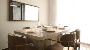 a dining room table with wine glasses and chairs at Luxury Villa’s in Orllan