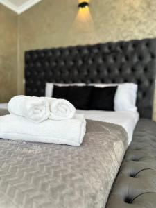 a bedroom with a bed with towels on it at Luxury Villa’s in Orllan