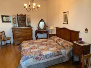 una camera con letto, cassettiera e specchio di La Porta di San Domenico a Sessa Aurunca