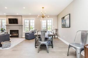 a dining room with a table and chairs and a fireplace at Our Special “Boutique” Quality Home in Old Towne in Niagara-on-the-Lake