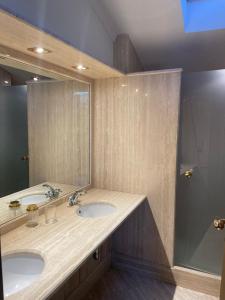 a bathroom with two sinks and a large mirror at CIVICO 16 in Chiaravalle