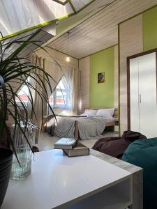 a room with two beds and a potted plant at ЛемГора in Vorokhta