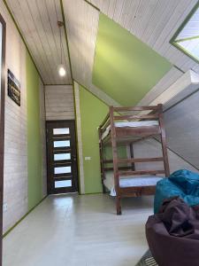 a room with two bunk beds in a room with green walls at ЛемГора in Vorokhta
