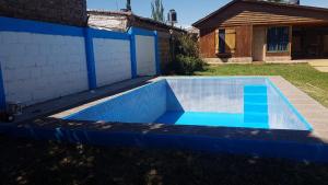 a swimming pool in the yard of a house at Cabañas del Sol in Vista Flores