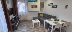 a living room with a couch and a table at Flory Holiday in Sibiu