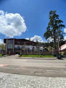 an empty street in front of a building at Two sisters in Bakuriani