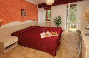 Postel nebo postele na pokoji v ubytování Hotel Augusta Garnì