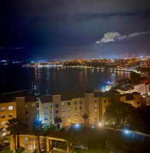 a view of a city at night with a body of water at Precioso depto vista al mar Concon Condominio Tipo Resort 2 dormitorios in Concón