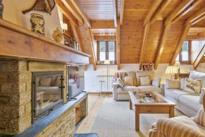 a living room with a large stone fireplace at Luderna - Dúplex Gessa C9 dera Montanheta in Gessa
