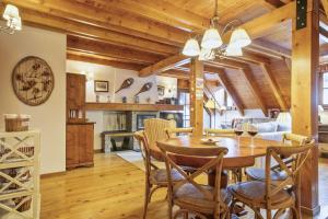 a dining room with a wooden table and chairs at Luderna - Dúplex Gessa C9 dera Montanheta in Gessa