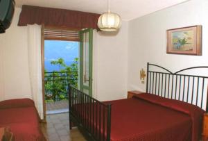 Postel nebo postele na pokoji v ubytování Hotel Augusta Garnì