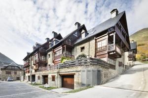 a large stone house with a black roof at Luderna - Dúplex Gessa C9 dera Montanheta in Gessa