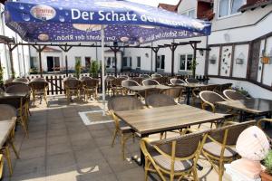 a row of tables and chairs on a patio at Ilmenauer Hof in Ilmenau