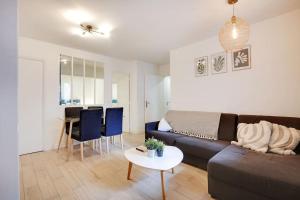 a living room with a couch and a table at Charming FLAT - Père Lachaise in Paris