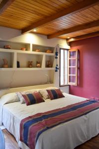 um quarto com uma cama grande e uma parede vermelha em Catalina Apart em San Salvador de Jujuy