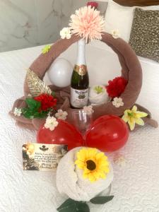 a wreath with a bottle of champagne and flowers on a bed at Hotel La Casa del Capi in Holbox Island