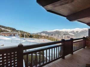 a balcony with a view of a ski slope at Appartement neuf à Courchevel 1850 avec accès direct aux pistes, piscine et SPA - FR-1-564-108 in Courchevel