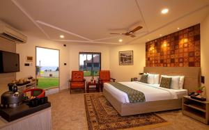 a hotel room with a bed and a television at MGM Beach Resorts East Coast Road in Chennai