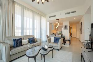 un soggiorno con divano e tavolo di Veluxa - Luxe 2Bed in Downtown! a Dubai