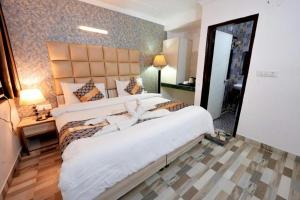 a hotel room with two beds and a mirror at HOTEL CLINK A Butique Airport Hotel in New Delhi