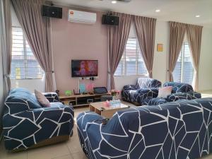 a living room with two couches and a tv at Sekinchan 2008 Home：Karaoke/BBQ in Sekincan