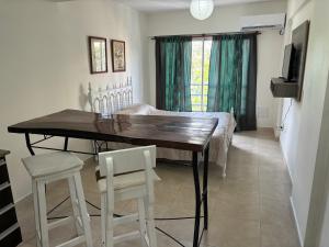 a dining room with a table and two chairs at Apart Momias del Llullaillaco II Anexo Av. Belgrano in Salta