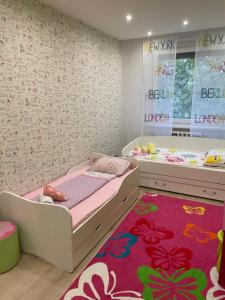 a bedroom with a bed and a large rug at Igényes Lakás in Szeged