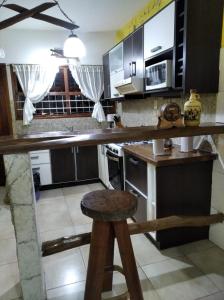 cocina con encimera de madera y taburete en Casa faro de Evangelina en Mar del Plata