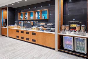 a bakery counter with a lot of food on display at SpringHill Suites by Marriott Kansas City Plaza in Kansas City