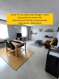 a living room with a table and chairs at Meublé de tourisme 2* les Jardins de l Arquebuse in Dijon