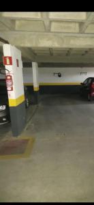 a parking garage with a car parked in it at Apartamento 3 Quartos - 807D in Contagem