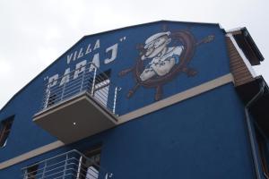 a blue building with a mural on the side of it at Villa Papaj in Międzyzdroje