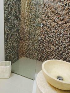 a bathroom with a sink and a tiled shower at Apartament Sophie in Sibiu