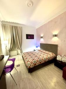 a bedroom with a bed and a table and chairs at Chroma Italy - Chroma Tessera in Rome