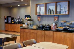 a restaurant with a counter with food on it at Springhill Suites by Marriott Frankenmuth in Frankenmuth
