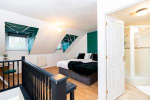 a bedroom with a king sized bed and a staircase at Ushaw House in Durham