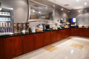 a kitchen with wooden cabinets and a large mirror at SpringHill Suites Dulles Airport in Sterling