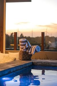 a towel and towels sitting next to a swimming pool at Maré Loft Praia in Icaraí