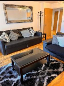 a living room with a couch and a coffee table at Luxurious river view apartment in London