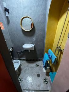 a bathroom with a sink and a toilet and a mirror at Vue imprenable à Essaouira in Diabat